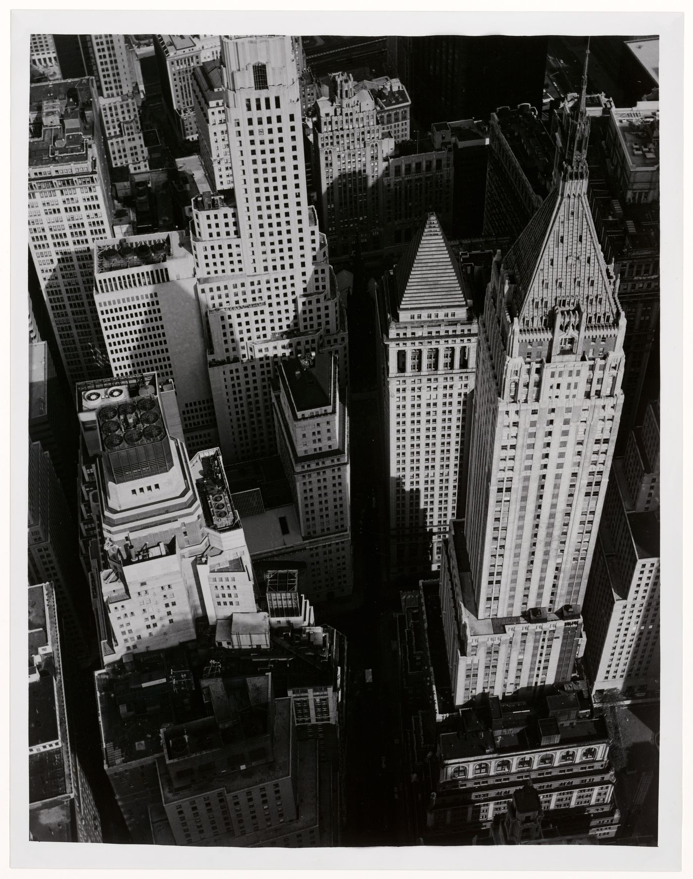 Aerial view of Wall Street looking west and showing the 40 Wall Street building in the foreground on the right and the Irving Trust Company building in the background on the centre left, New York City, New York, United States