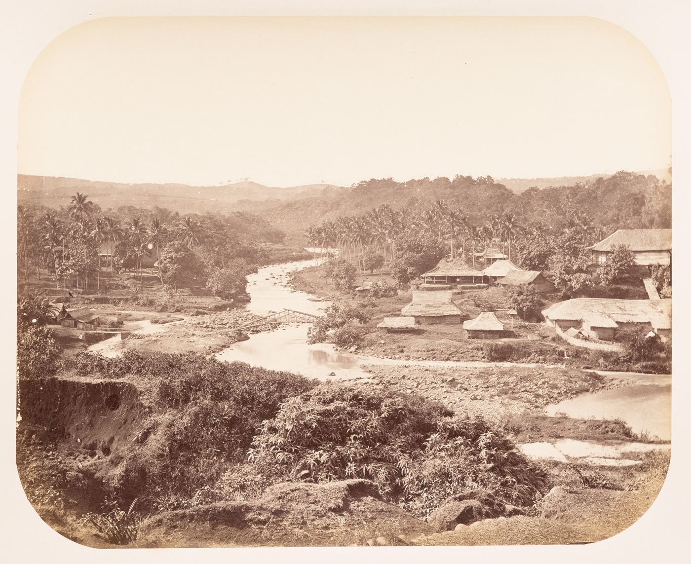 View of a bridge, a river and a village, near Buitenzorg (now Bogor), Dutch East Indies (now Indonesia)