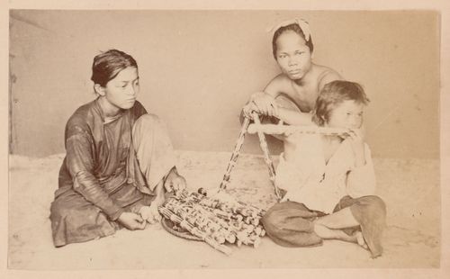 Group portrait of three people, probably in Cochin China (now in Vietnam)