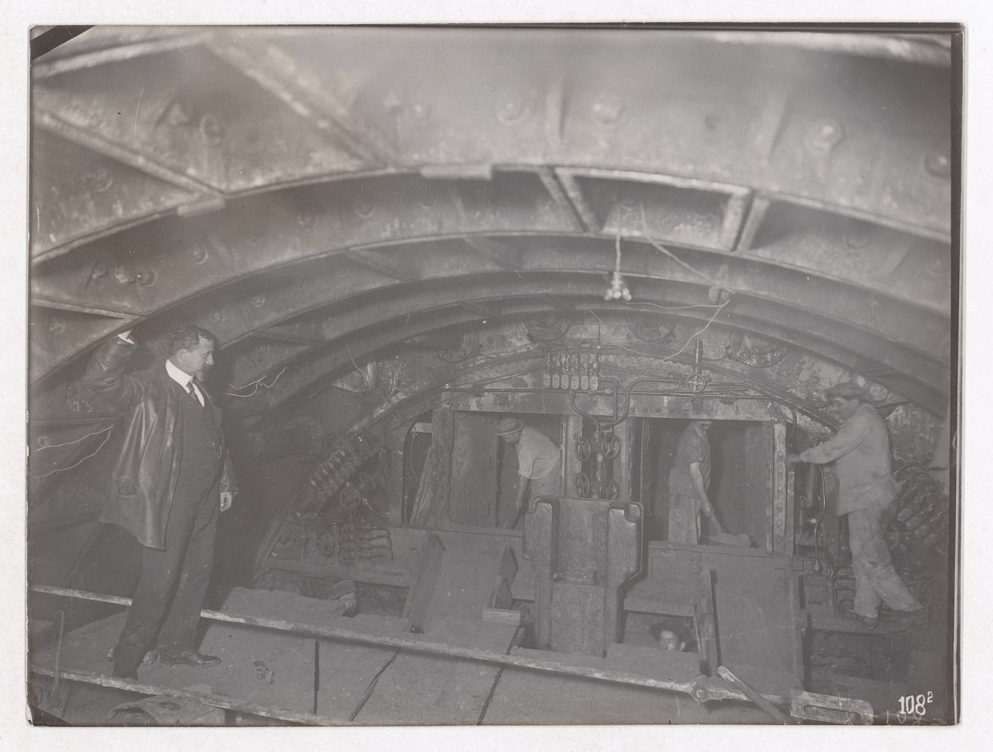 Construction of the Paris Metro, interior view with workers in a room with a low ceiling, Paris, France