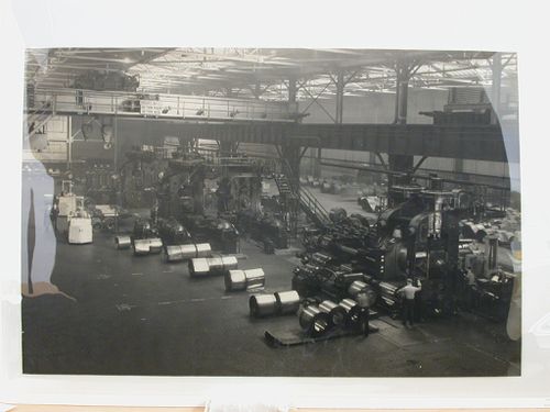 Men working in machine shop, Clevel, San Francisco, Californiaand Crane sign on balcony level, San Francisco, California