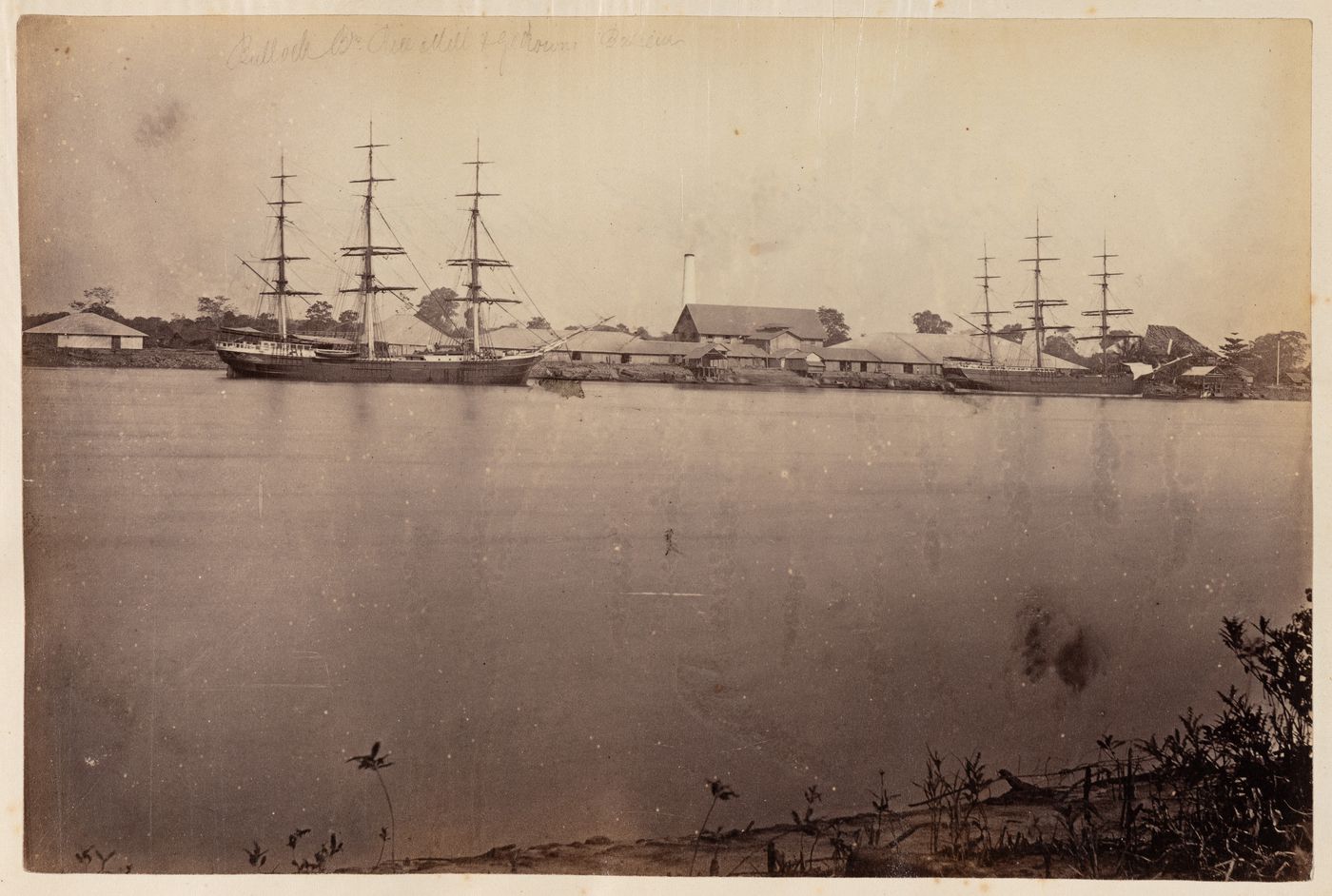 View of a harbour, ships and a rice mill, Bassein, Burma (now Myanmar)