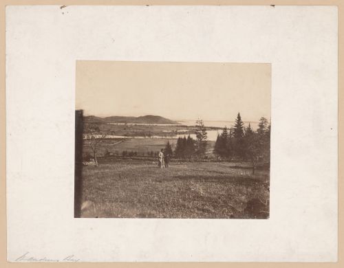 View of a man and a boy standing in a field with Passamaquoddy [?] Bay in the background, St. Andrews [?], New Brunswick [?], Canada [?]