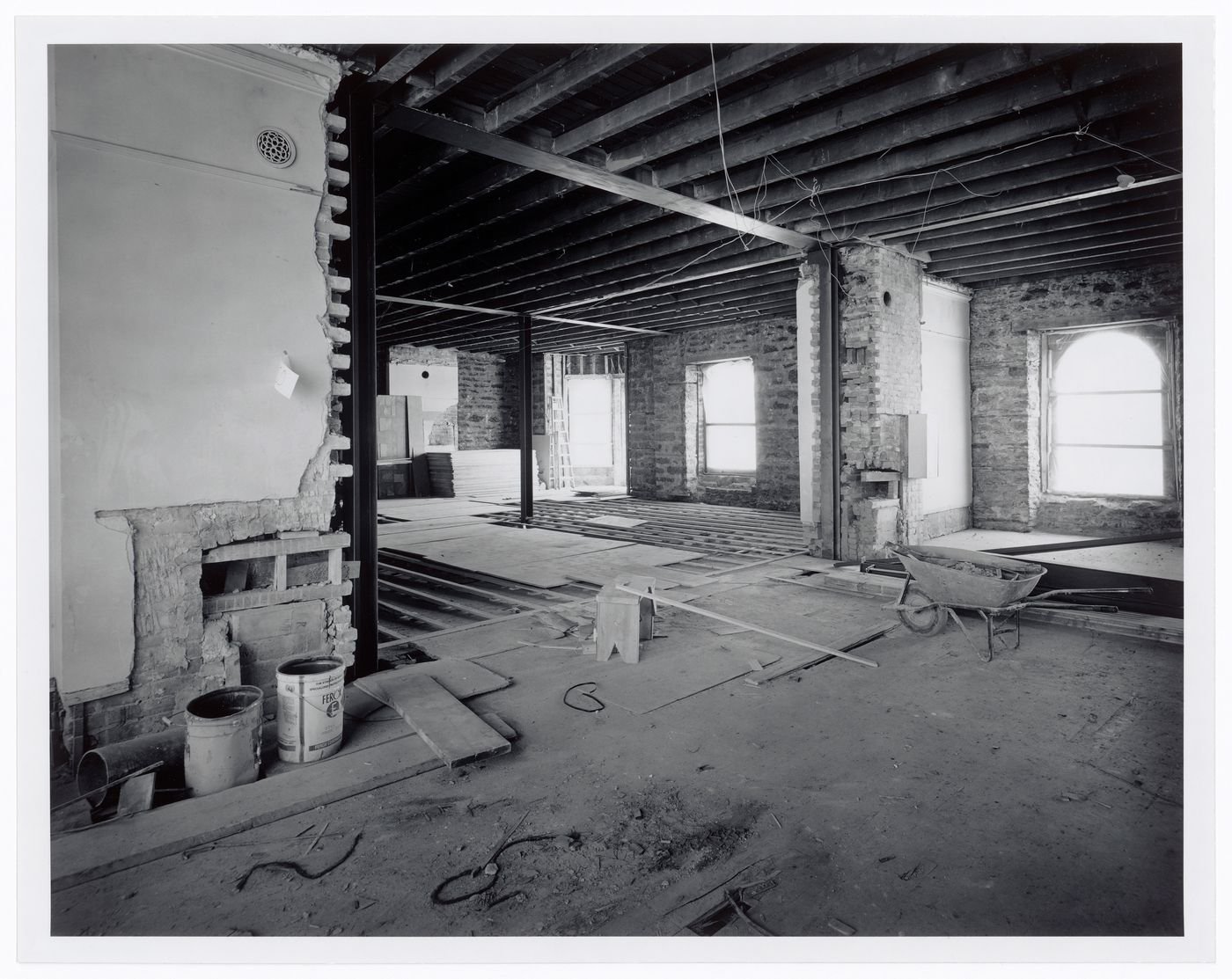 Interior view of level 5 or 6 stripped to the brick walls and ceiling joists, Shaughnessy House under renovation, Montréal, Québec