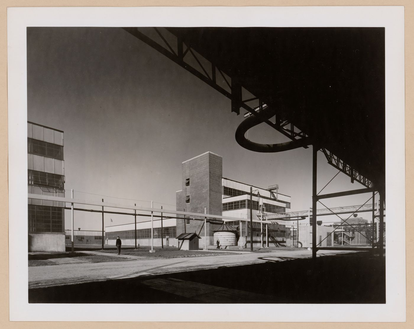 View of the principal and lateral façades of the Coagulation Building with a warehouse in the background, B.F. Goodrich Company Geon Plant, Louisville, Kentucky