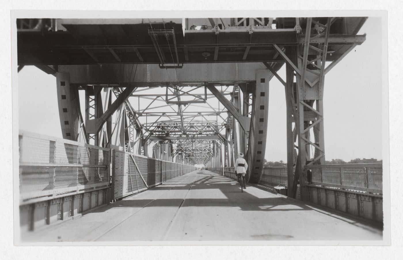 View of man riding a bicycle on the Blue Nile Road and Railway Bridge, Khartoum, Sudan