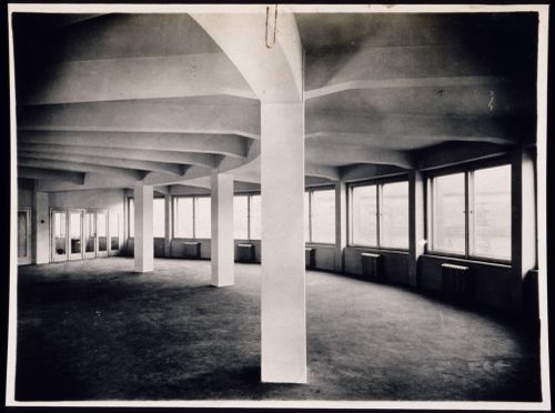 Interior view of a circular hall with columns and windows