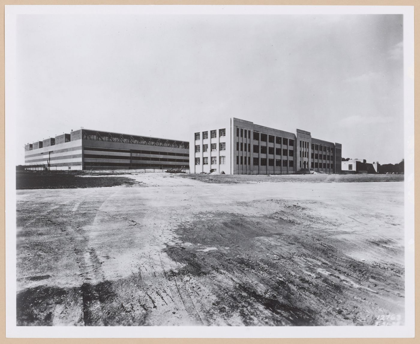 View of the principal and lateral façades of the [second] Assembly Building on the left and the Administration Building in the centre, both under construction, Glenn L. Martin Company Navy Assembly Plant No. 2, Middle River, Maryland
