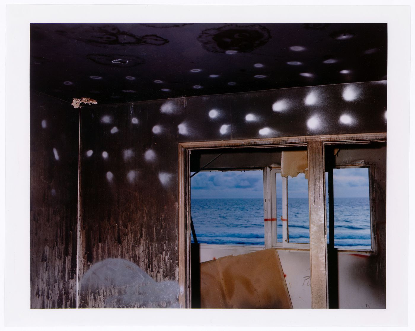 Abandoned beach house, white dots on wall and ceiling around windows, California ?