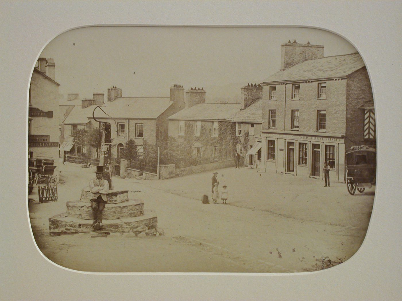 View of a village square with several houses and figures, and a coach at the right, England ?