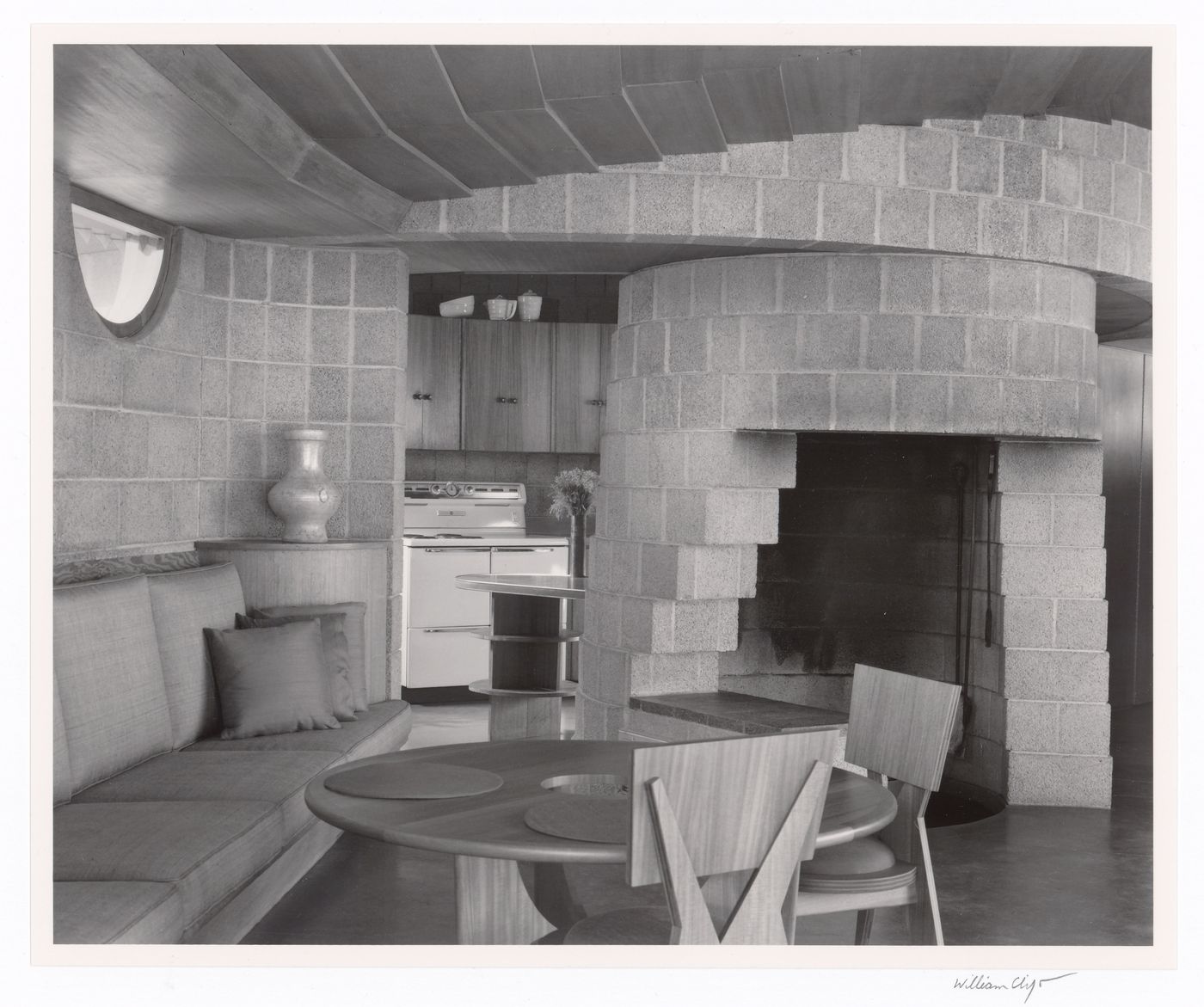 Living room and fireplace with kitchen beyond, from the series The David and Gladys Wright House