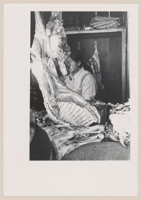 Butcher with butchered animal, South America