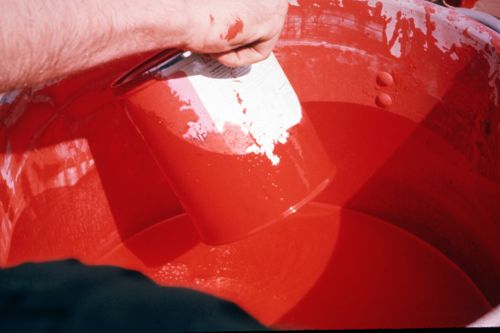 Photograph of red paint can during performance of Red Line