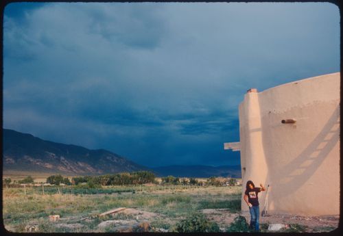 Child and  adobe building, Taos, New Mexico