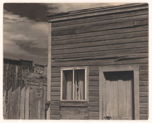 Southwestern town: Wooden houses and fences, close up, receding into distance