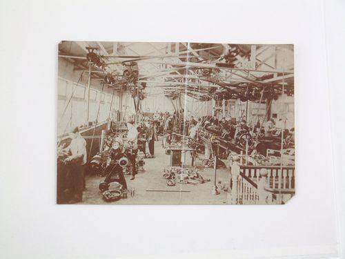 Interior view of factory with laborers