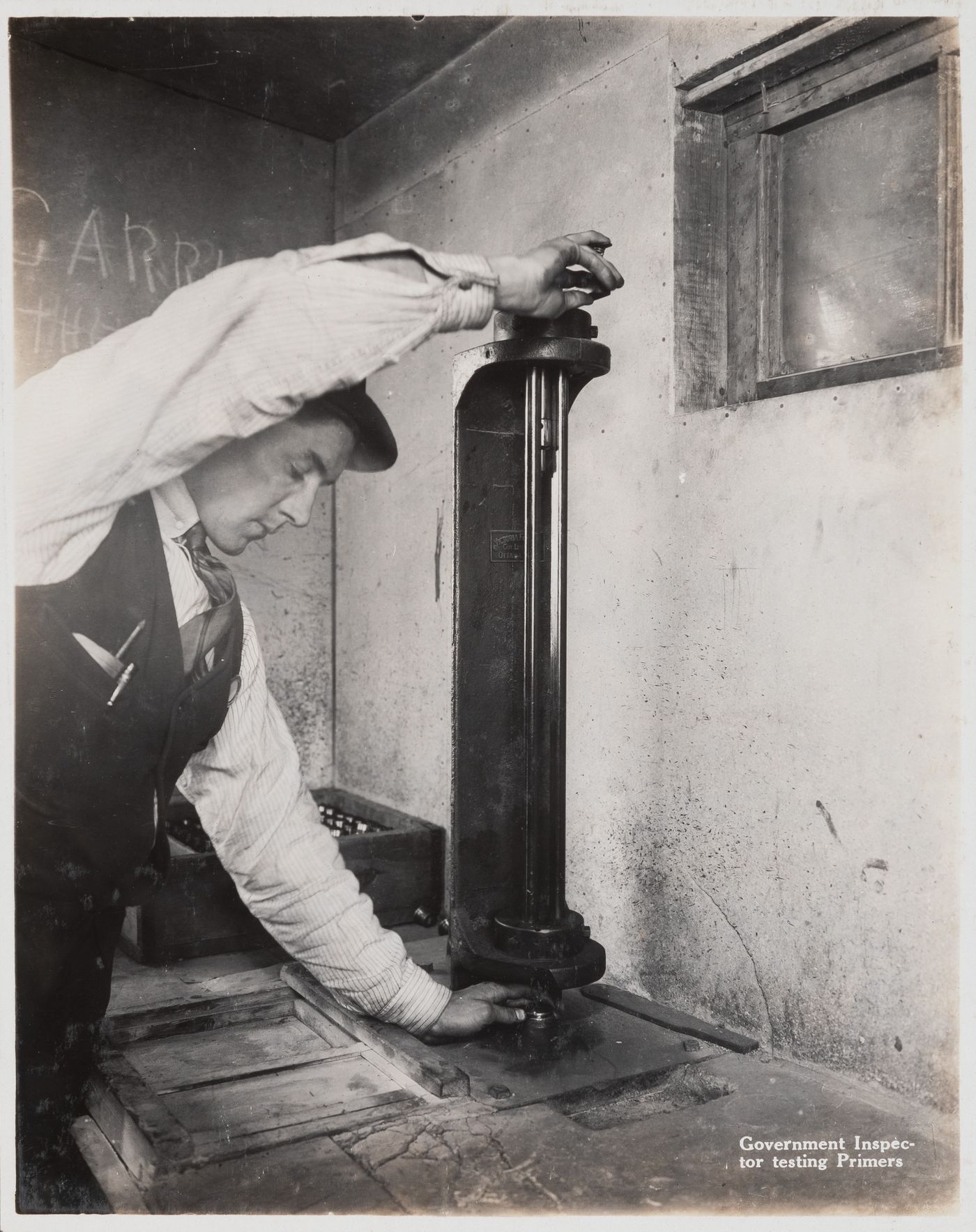 Interior view of inspector testing primers at the Energite Explosives Plant No. 3, the Shell Loading Plant, Renfrew, Ontario, Canada