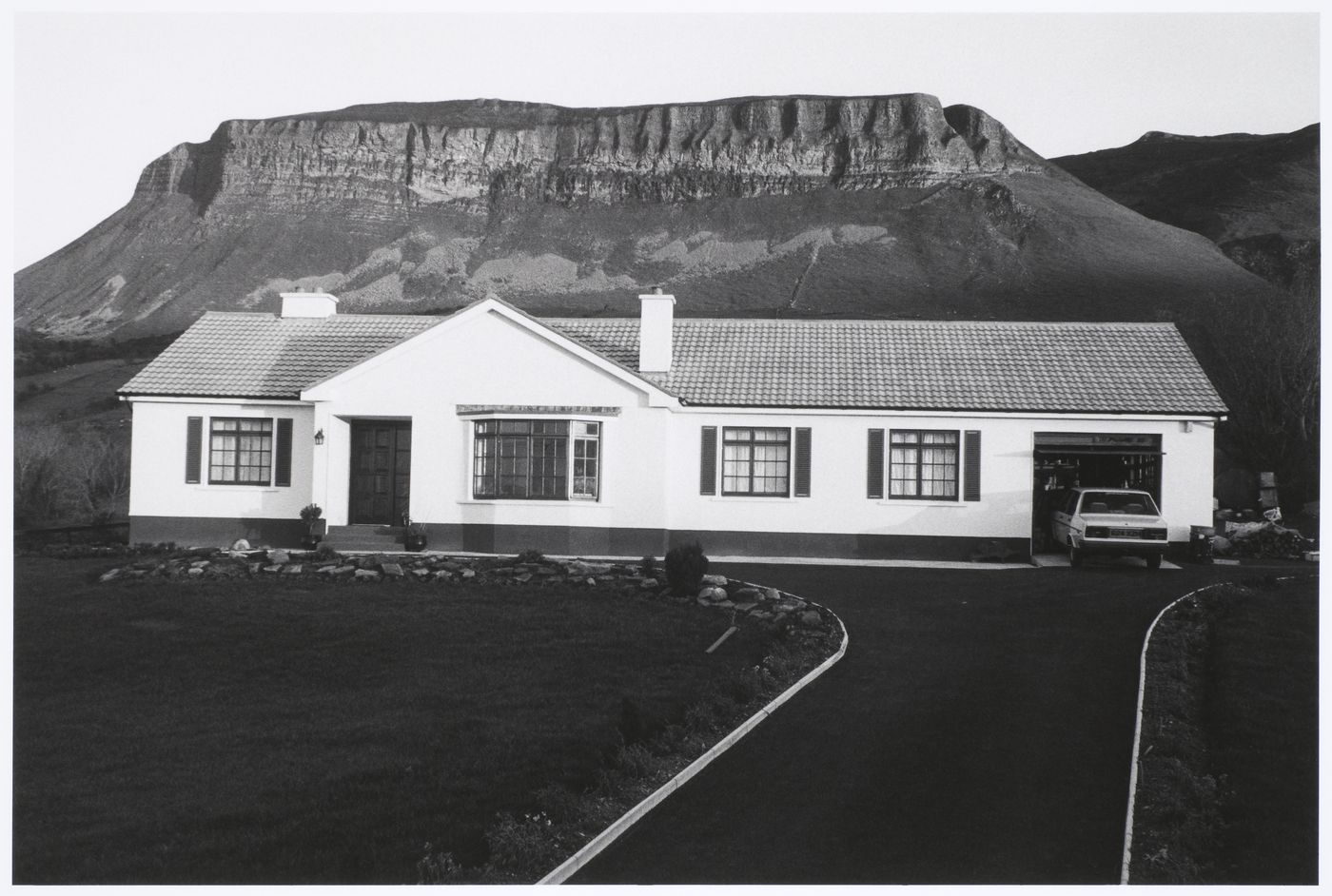 Bungalow in front of rock formation, Glencar, County Sligo, Ireland