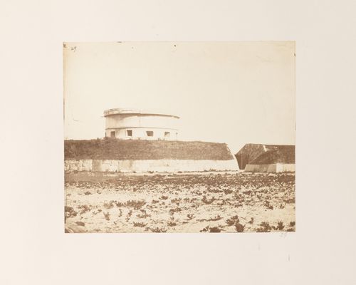 View of coastal fortifications showing a martello tower and defensive walls, near Kobe, Japan