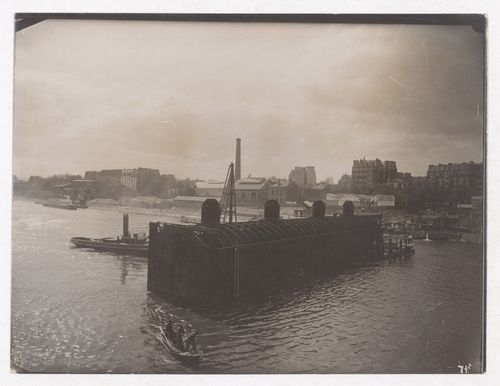 Construction of the Paris Metro, exterior view of a caisson, workers and the Seine, Paris, France