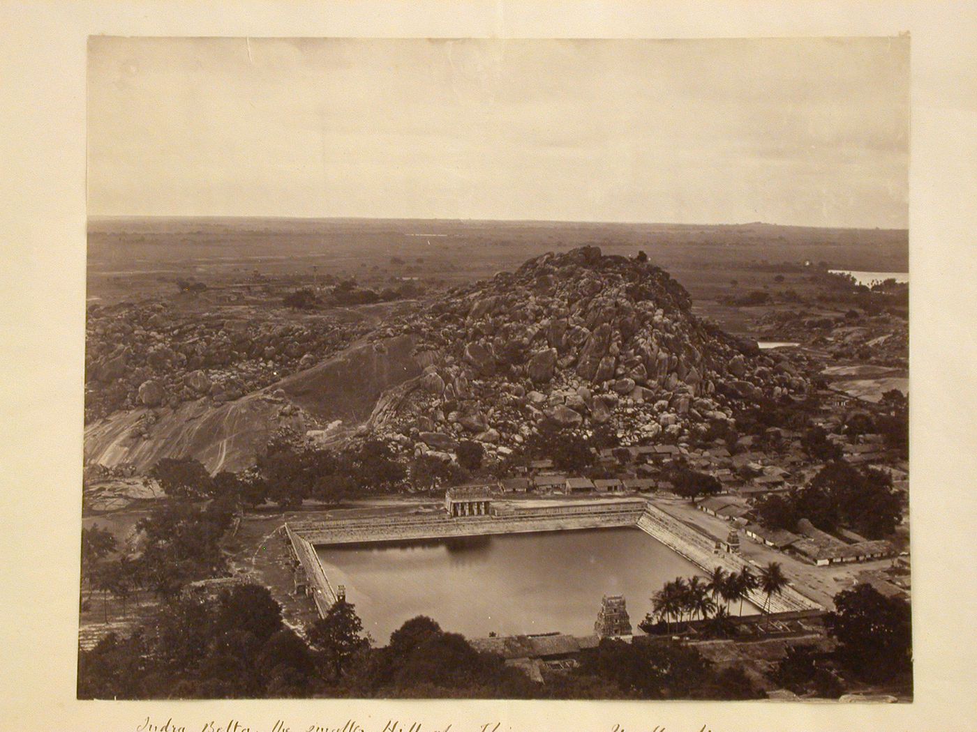 View of Chandragiri with a water tank and buildings in the foreground and temples, including the Parshvanatha Basti and Chamundaraya Basti (also known as the Camunda Raya Basti) in the left background, Shravana Belgola (now Sravana Belgola), India