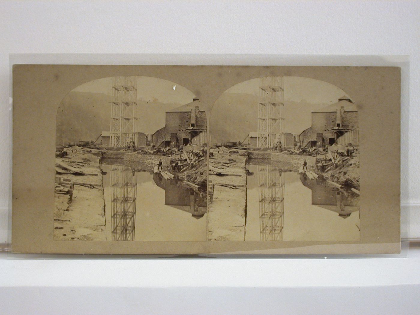 Stereograph of the Crumlin Viaduct under construction showing one of the structural piers and a building site [?], Monmouthshire (now in Gwent County), Wales