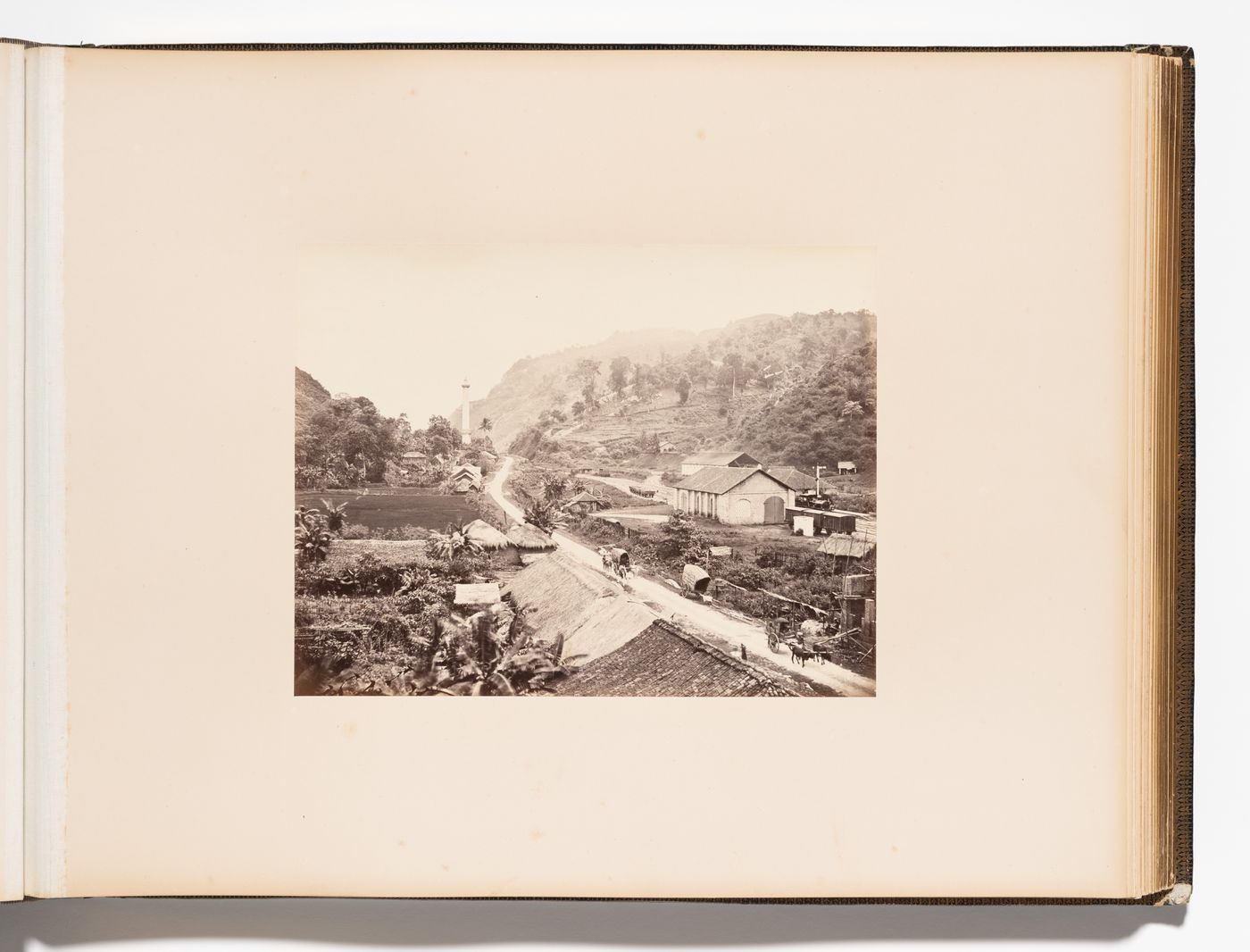 View of Kadugannawa showing a road, hills and buildings with the railroad station on the right and Captain Dawson's Monument in the background, Ceylon (now Sri Lanka)