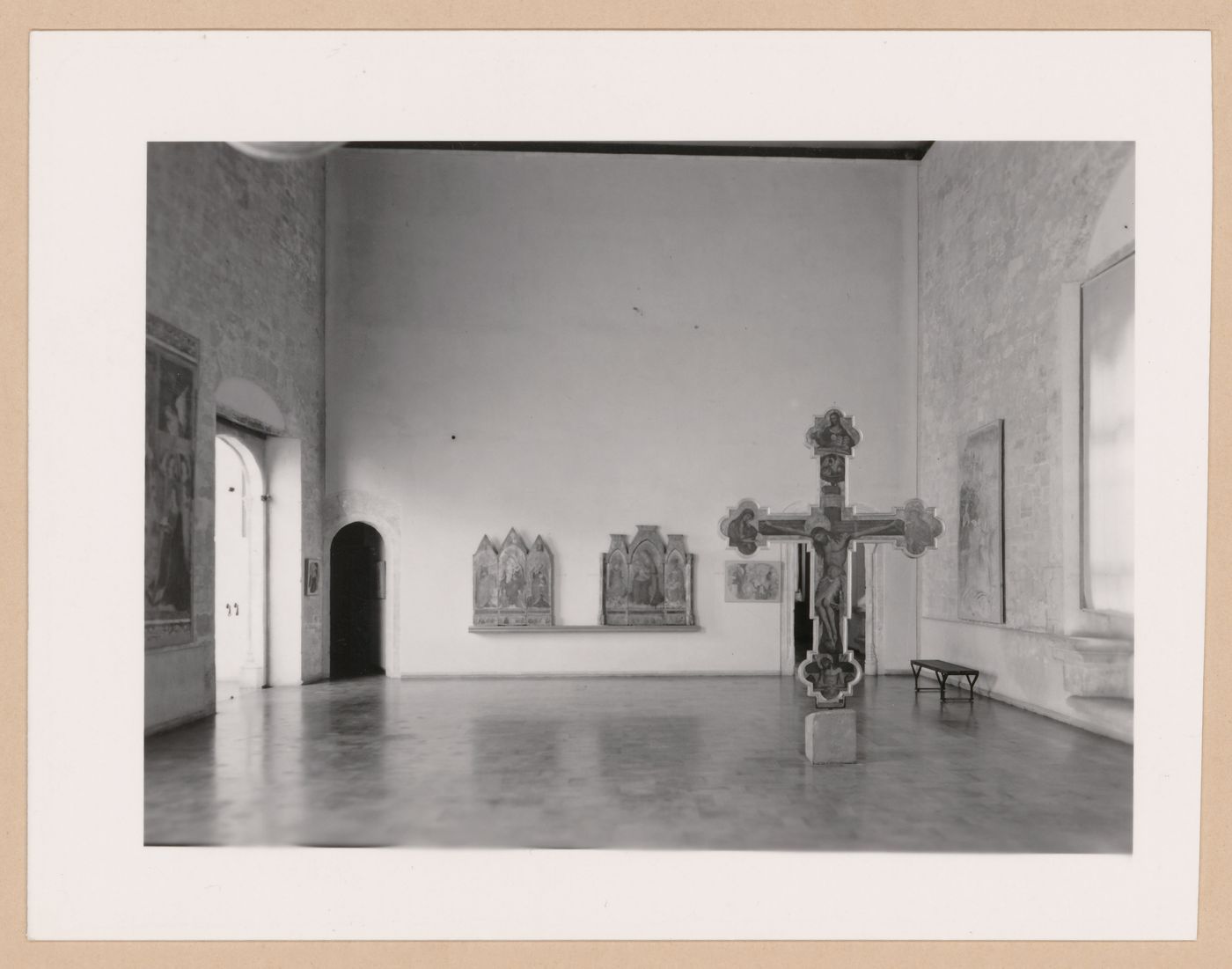 Interior view of a gallery showing a freestanding painted crucifix and paintings, Palazzo Abatellis, Galleria regionale della Sicilia, Palermo, Italy