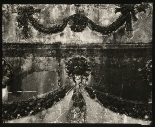 Relief design of floral patterns and lion head on stone wall, County Mayo, Ireland