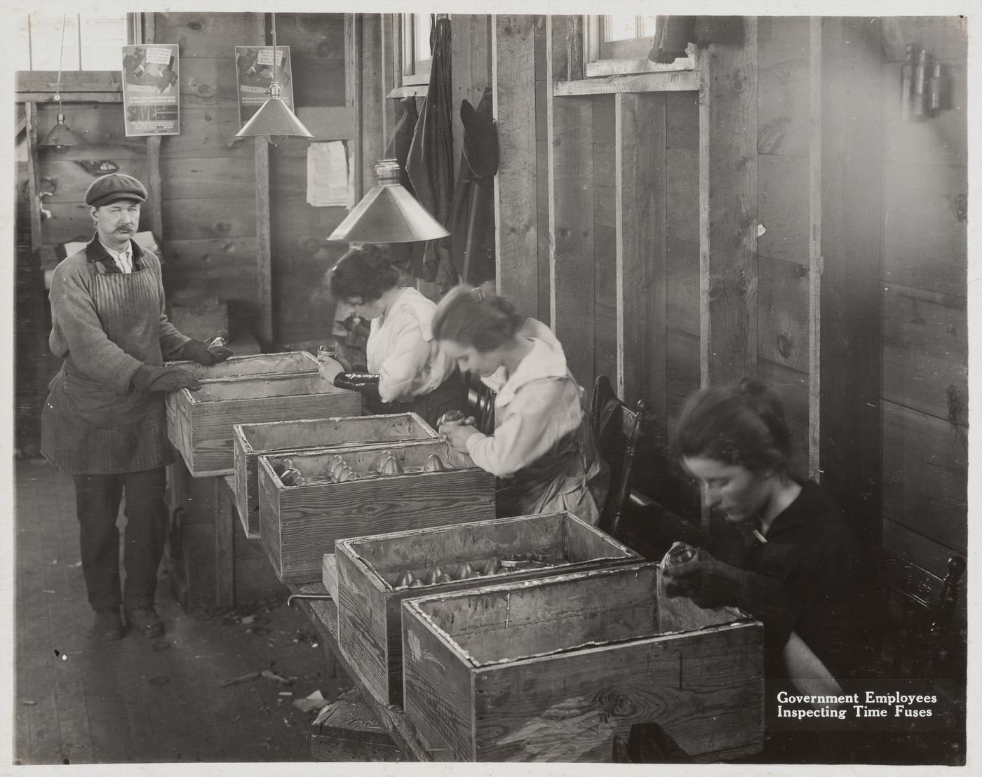 Interior view of workers inspecting time fuses at the Energite Explosives Plant No. 3, the Shell Loading Plant, Renfrew, Ontario, Canada