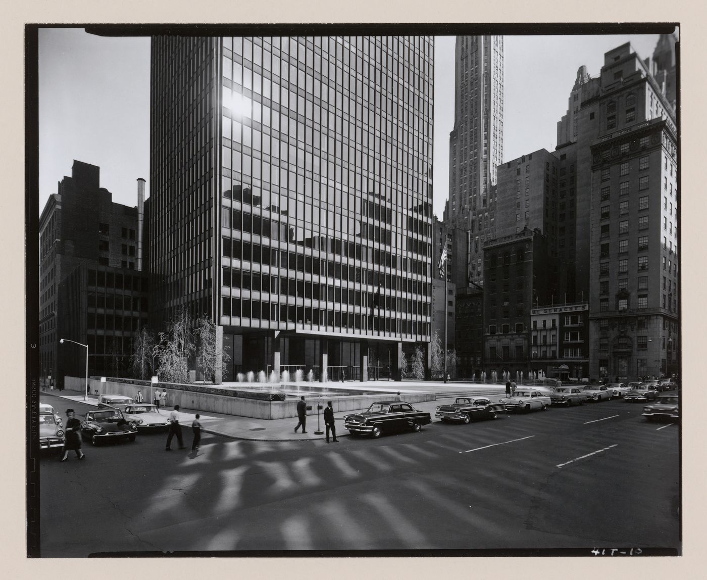 Partial view of the west façade and plaza of the Seagram Building from across the street showing the surrounding buildings reflected in the windows, New York City