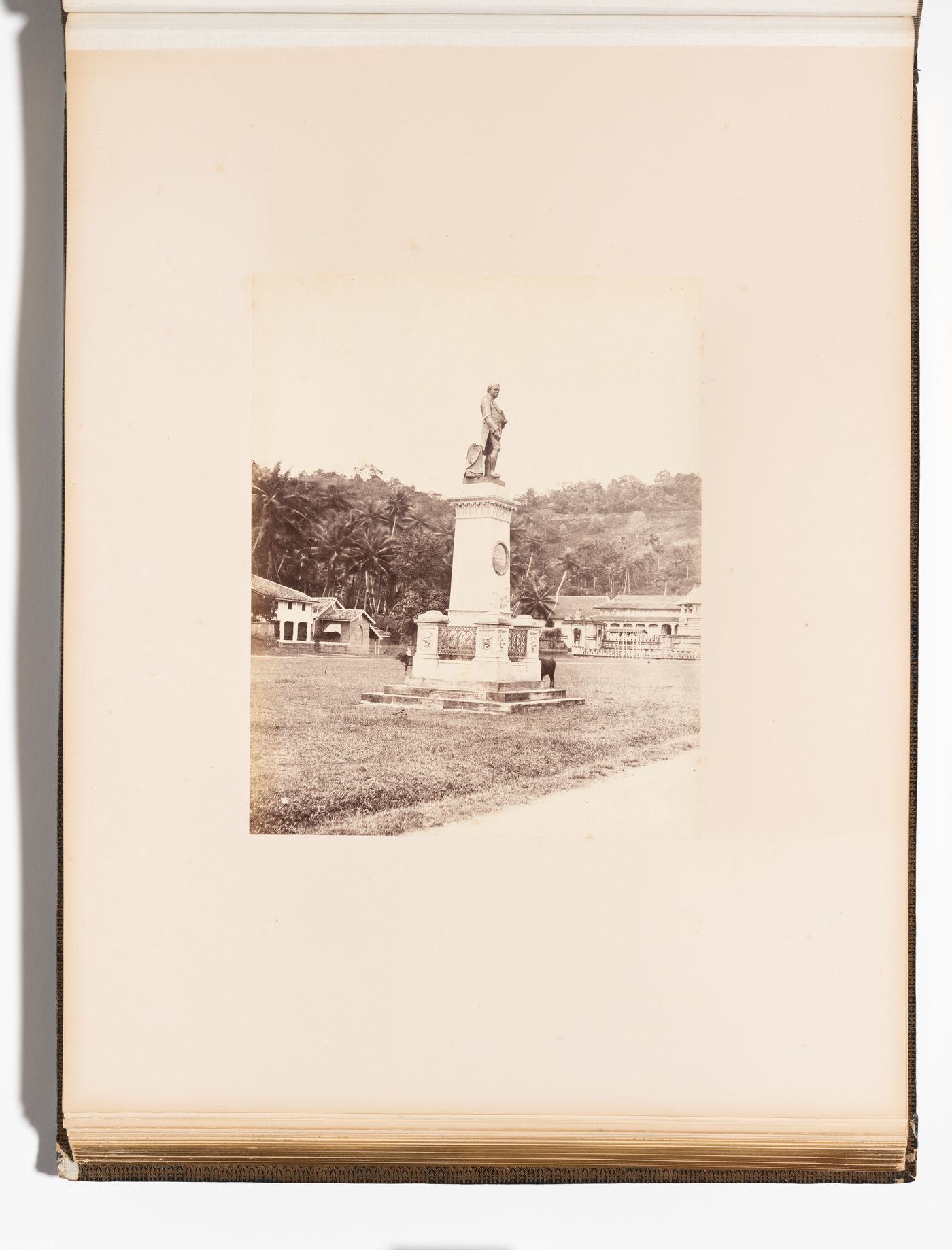 View of the statue of Sir Henry George Ward with the Temple of the Tooth (also known as the Sri Dalada Maligawa) in the background, Kandy, Ceylon (Sri Lanka)