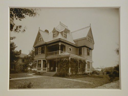 Three quarter view of wooden house and yard