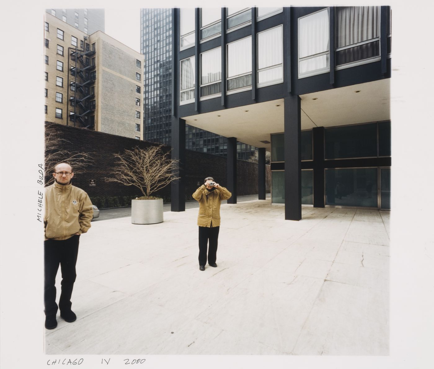 Exterior view of 880 Lake Shore Drive Apartments showing the photographer Michele Buda standing and Phyllis Lambert taking a photograph, Chicago, Illinois