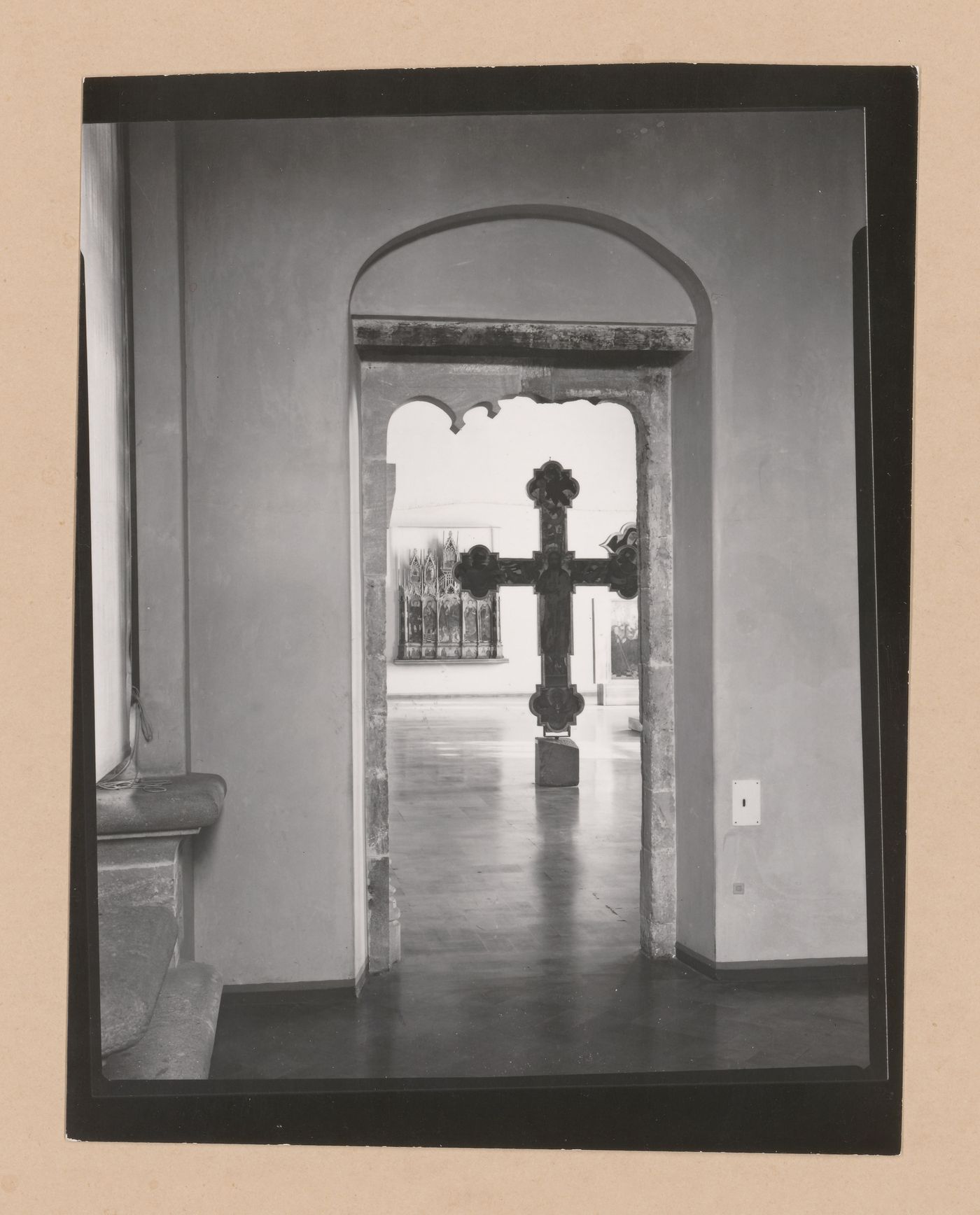 View of a gallery showing a doorway and a freestanding painted crucifix, Palazzo Abatellis, Galleria regionale della Sicilia, Palermo, Italy