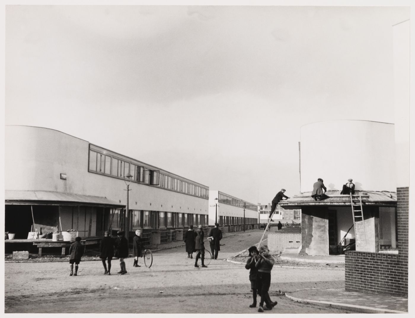 Exterior view of Kiefhoek Housing Estate showing corner stores under construction, Rotterdam, Netherlands