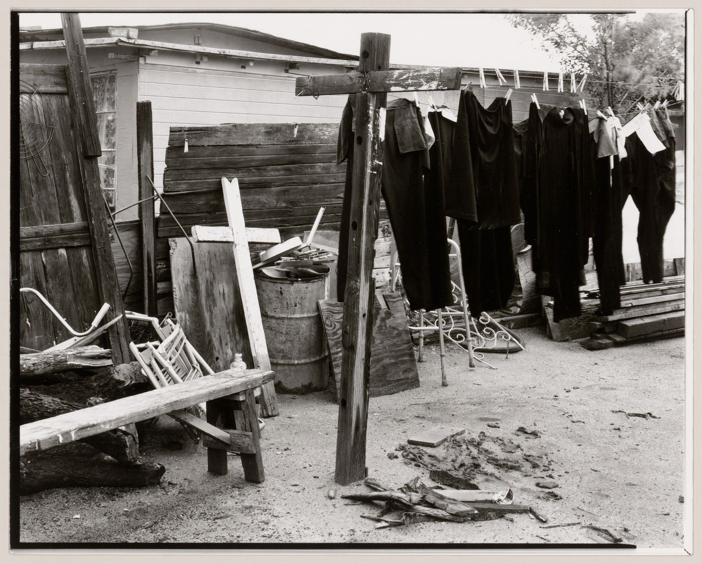 View of clothesline showing clothes drying with cross on the left, Old Pascua, Tucson, Arizona, United States (from a series documenting the Yaqui community of Old Pascua)
