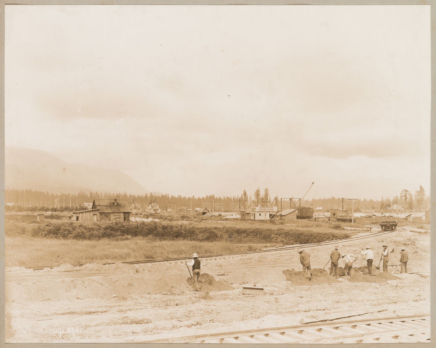 View of the Canadian Pacific Railroad Company freight yards and Roundhouse (centre background) under construction, Coquitlam (now Port Coquitlam), British Columbia