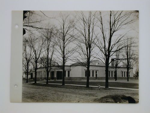 Exterior view of tree-lined street in front of school, Midwest