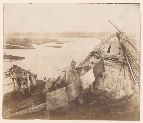 View of self-built wooden sheds with clothes line overlooking water (probably the Dnieper River) near Kiev, Russia (now Kyiv, Ukraine)