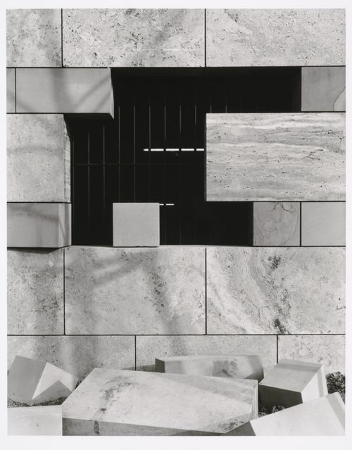 View of a barred window opening onto the parking garage of the Neue Staatsgalerie [New National Gallery] with cut stones in the foreground, Stuttgart, Germany
