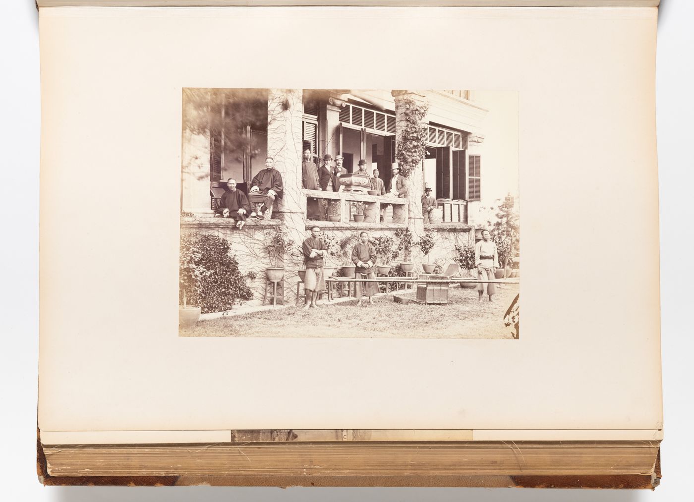 View of the veranda of a building showing men and a sedan chair, possibly Foochow (now Fuzhou), China