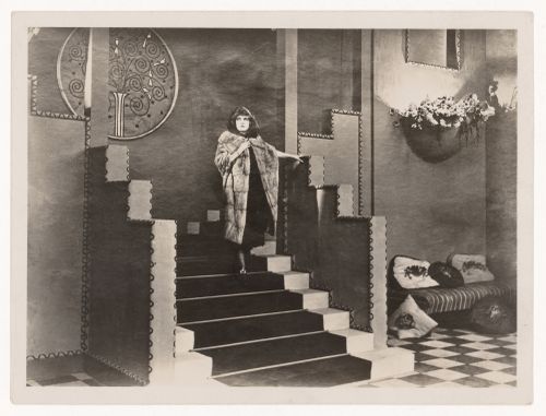 View of Lois Meredith descending staircase on the set of "Le Secret de Rosette Lambert" by Raymond Bernard, France