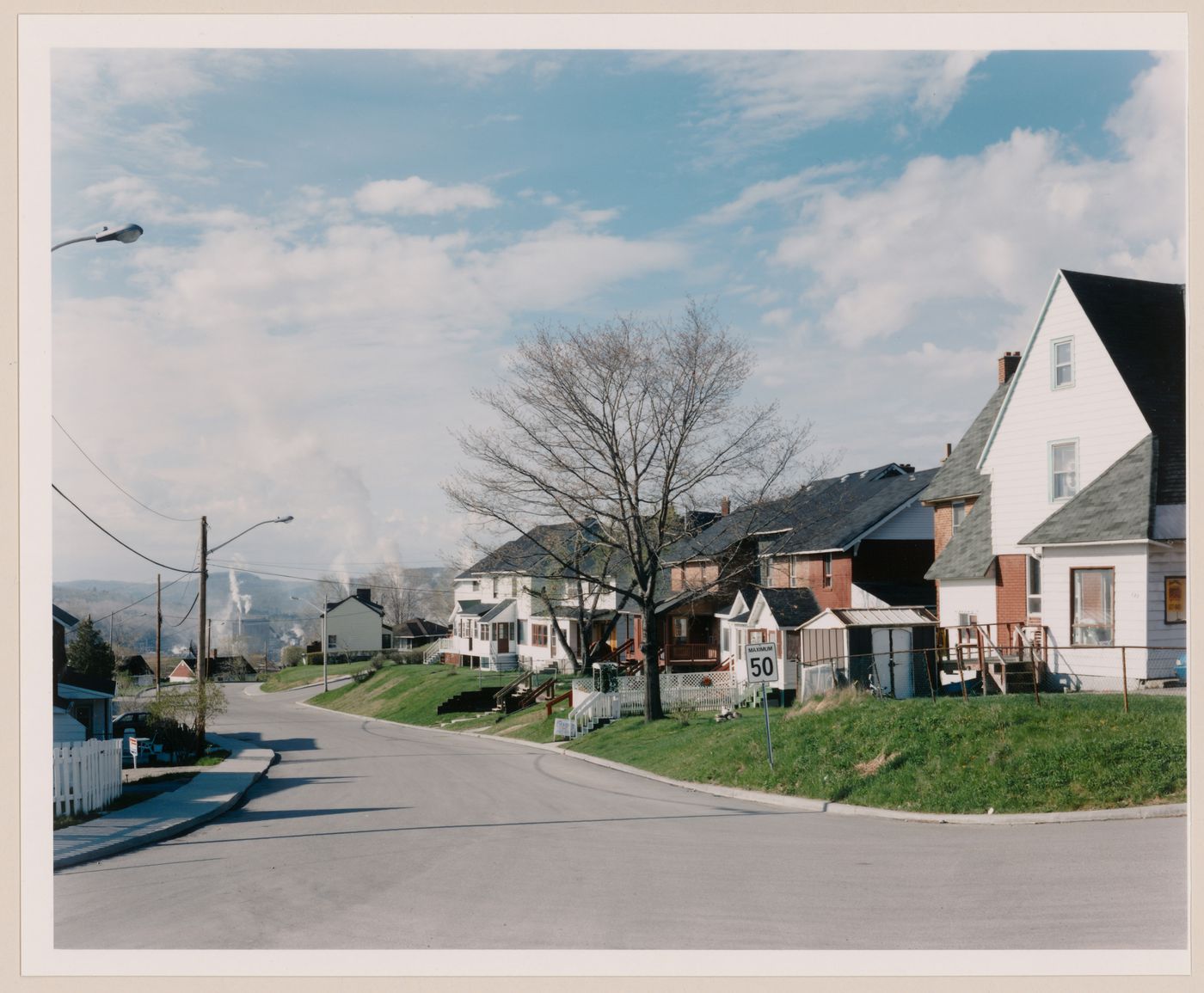 Section 1 of 2 of Panorama of workers' row housing on the corner of rue Paul E. Benoit and avenue Riordon looking south, Témiscaming, Quebec