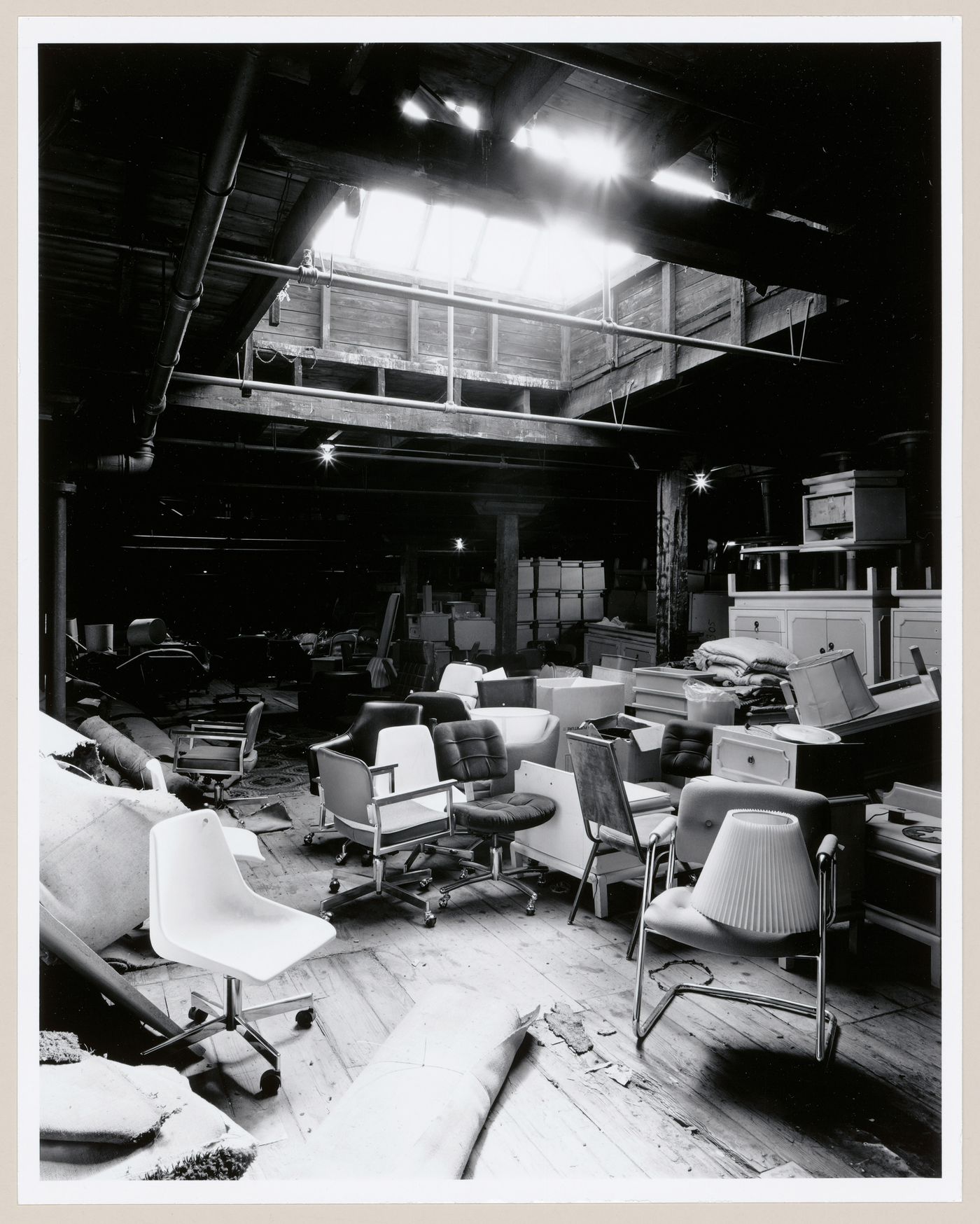 Interior view of a storage area on the fourth floor of Smith Street Warehouse showing office furniture and a skylight, Montréal, Québec