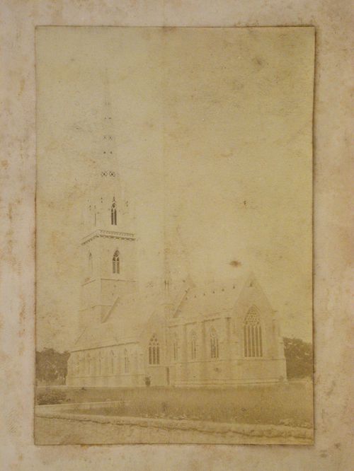 Rear view of a church showing the apse, an outer aisle and the church tower, England