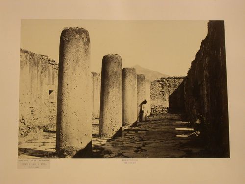 Interior view of the Palace of the Columns showing the Salón de las Columnas [Hall of Columns] and a man, Mitla, Mexico