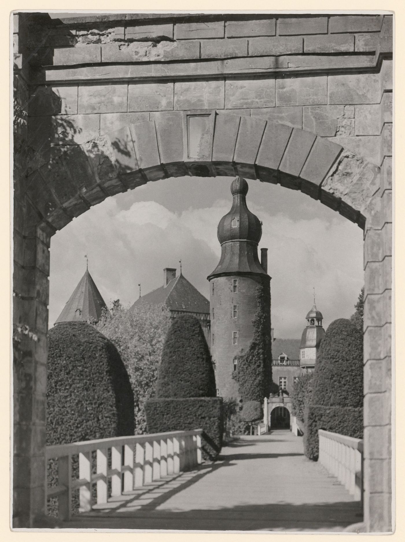 View of Wasserschloss Gemen through an archway and across a bridge, 3 towers visible, Westphalia, Germany