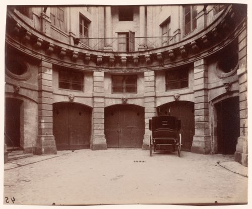 Hôtel de Beauvais: Back of courtyard showing garage doors and automobile, Paris, France