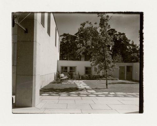 View of the garden of the Chapel of the Holy Cross showing a path, shrubs and trees, Woodland Crematorium and Cemetery, Stockholm